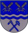 Durch einen silber-blau geteilten Wellenbalken geteilt von Blau und Silber. Oben links und rechts je zwei silberne Ähren schräggekreuzt, unten ein blauer Hammer und eine blaue Rodungshacke schräggekreuzt.