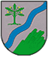 Silberner Schild durch schräglinke, blaue Wellenleiste geteilt. Rechts oben ein grüner Eichenbaum mit 5 Blättern und 4 goldenen Früchten; links unten ein grüner Bergkegel, von rechts nach links ansteigend, aus dem Schildrand wachsend zum oberen Rand hin Basaltsäulen bildend.