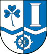 Gespalten von Silber und Blau. Über einer gesenkten Wellenleiste in verwechselten Farben vorn ein blaues Kleeblatt, hinten eine silberne Säule. Unten ein Mühlrad in verwechselten Farben.