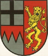 Halb geteilt und gespalten; vorne oben in Silber ein schwarzes Kreuz, unten von Rot über Silber durch einen Spitzenschnitt des silbernen Feldes in das rote Feld übergreifen